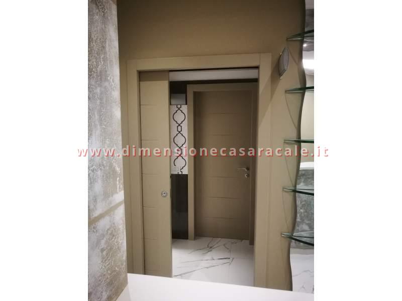 installazione in Lecce e provincia porte interne tamburate marchio Flessya linea Nidio 12 laccato Extra Grigio Becker 4477 12